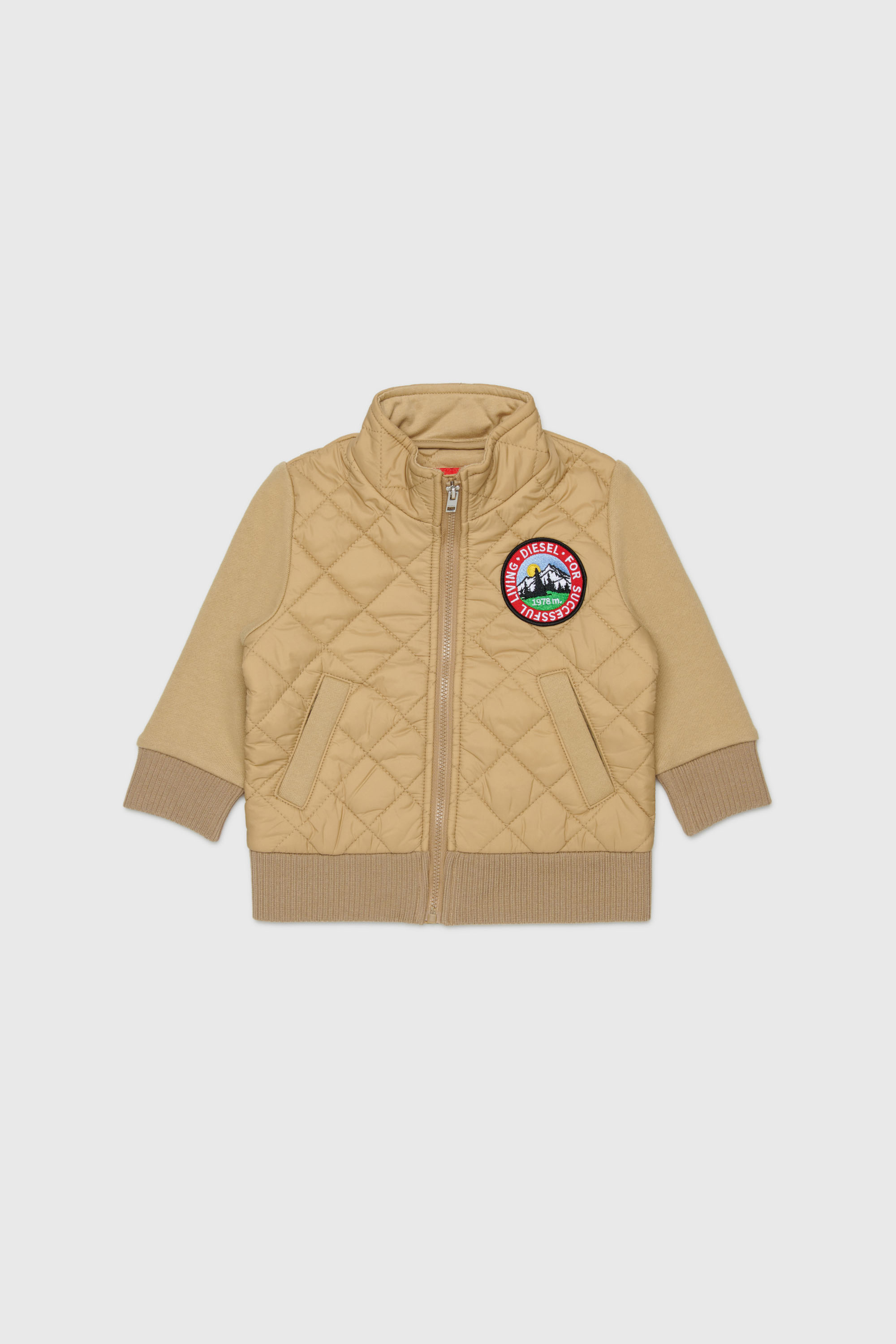 Quilted nylon jacket with cotton sleeves